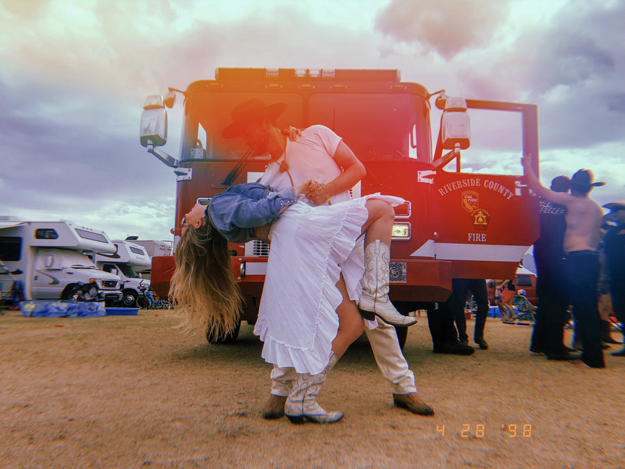 Jon dipping Jada in front of a fire truck at Stagecoach