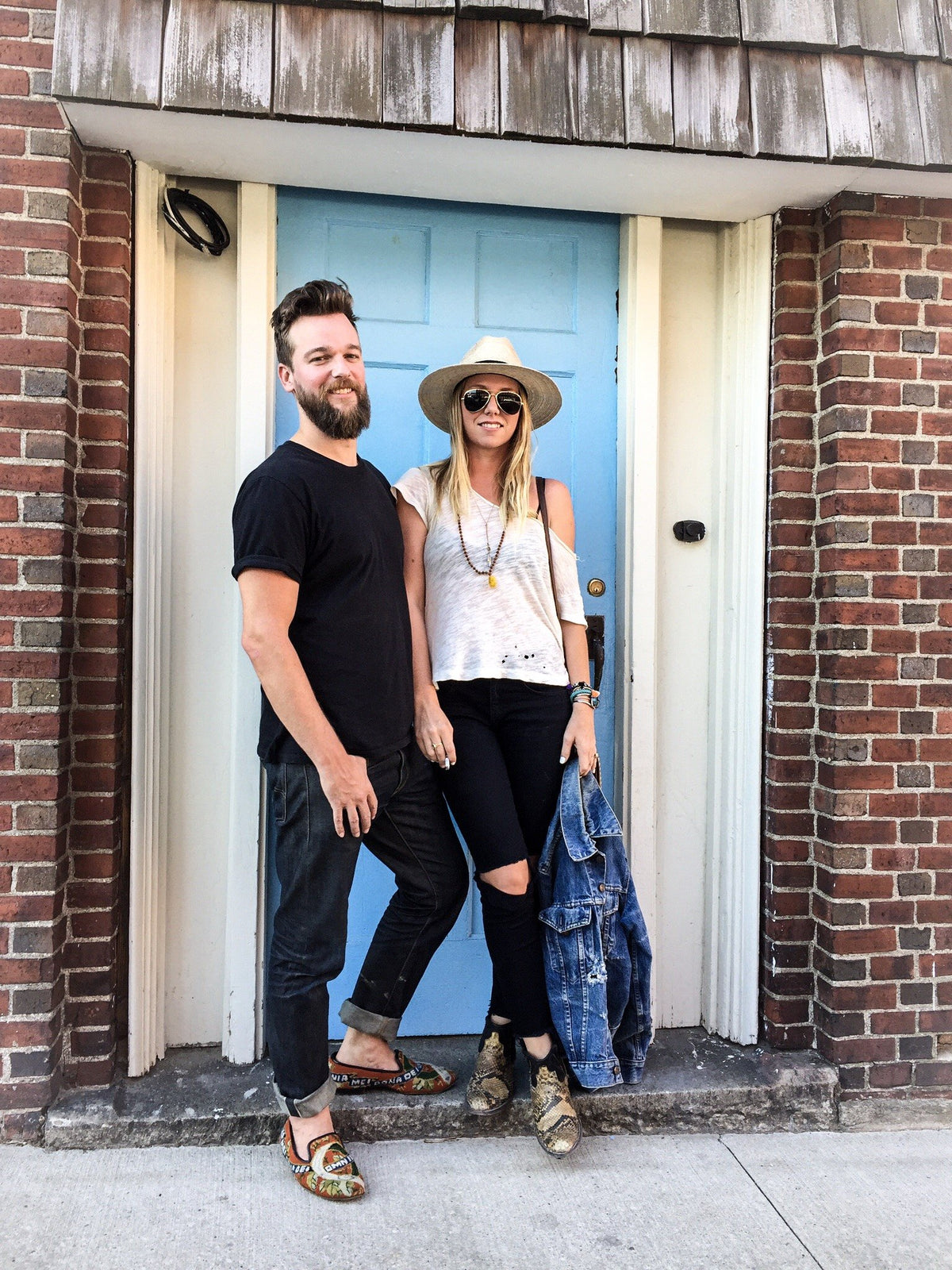 Jada and Jon in front of a blue door