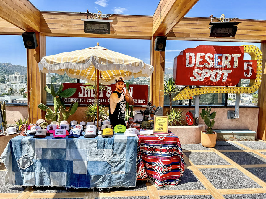 Jada & Jon booth with trucker hats at Desert 5 Spot