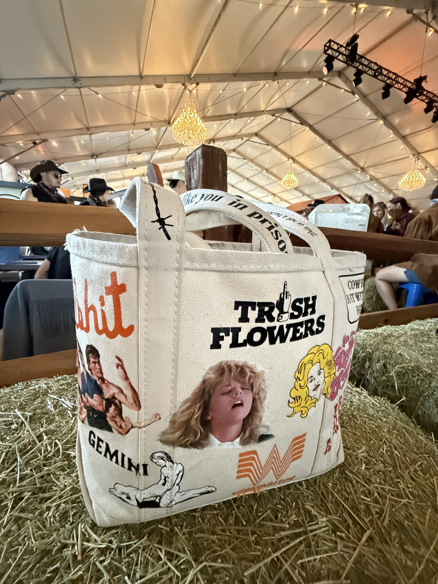 Trash Flowers tote on a hay bale at Stagecoach